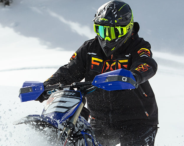 An image of a guy on a snowmobile wearing FXR's Maverick SX-Pro Pant
