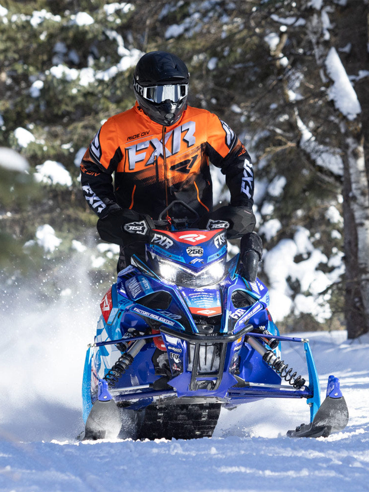 Action image of a guy snowmobiling on a trail wearing an FXR gear from FXR's Performance Crossover collection