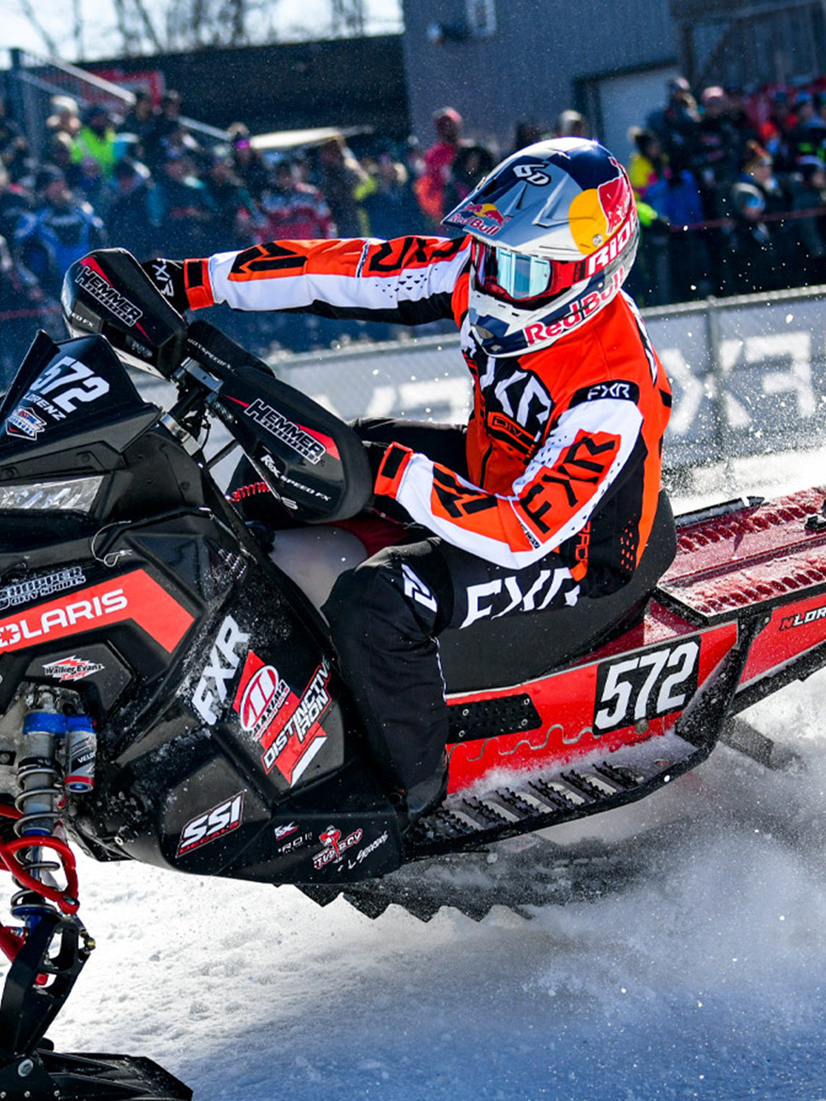 Action image of a guy on a snow race track sporting gear from FXR's race collection 