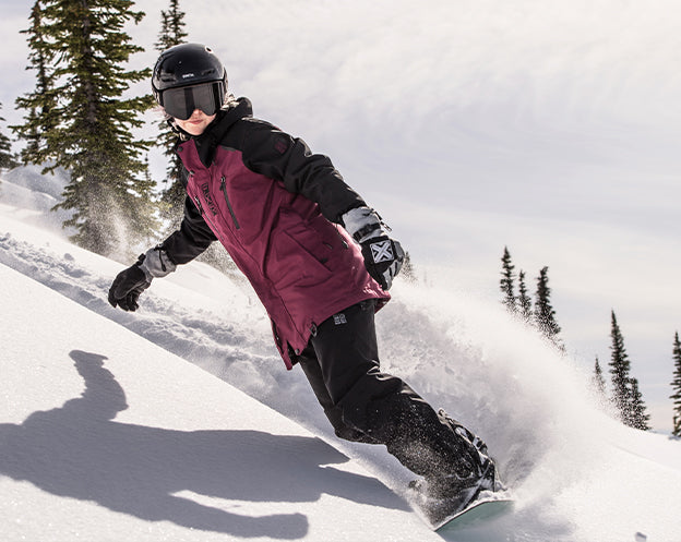 Image of guy going down on a snowy mountain hill snowboarding and sporting FXR's Men's Ridge 2-in-1 Jacket